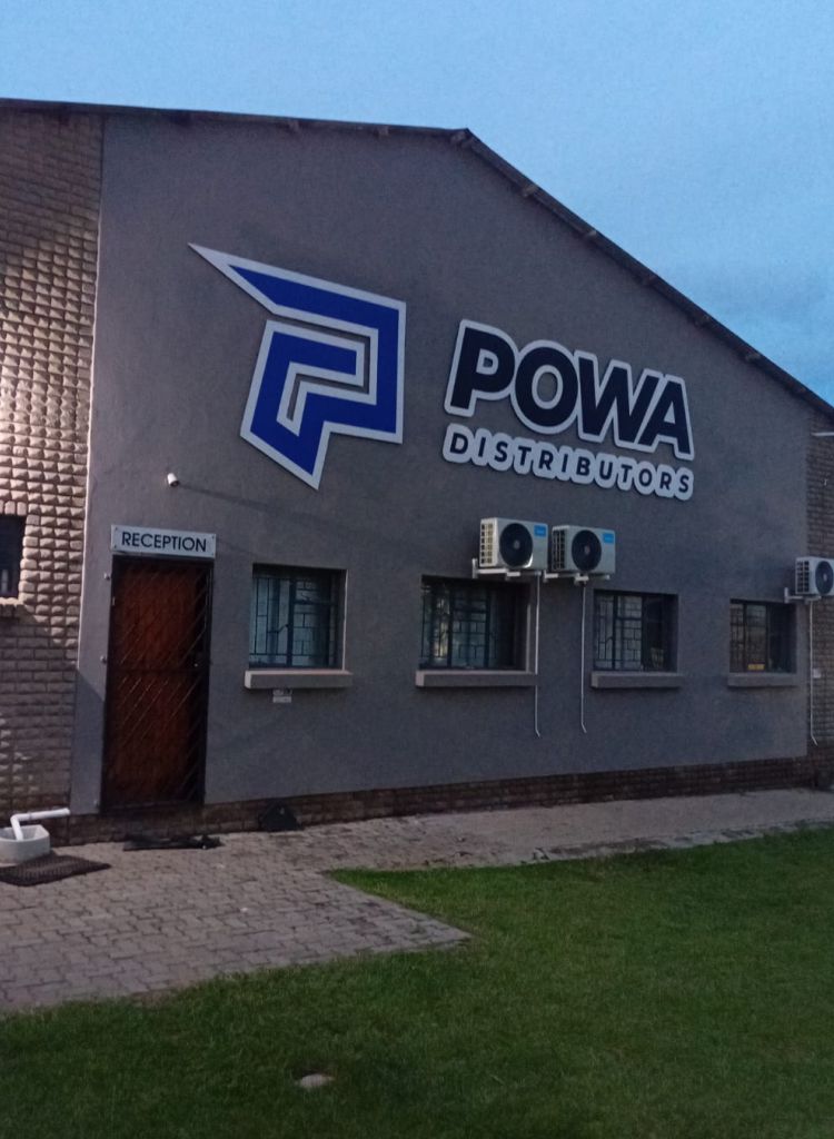Custom-fabricated ACM signage for POWA Distributors installed on 25mm stand-offs to create a 3D floating effect on an industrial building facade by Specifusion.